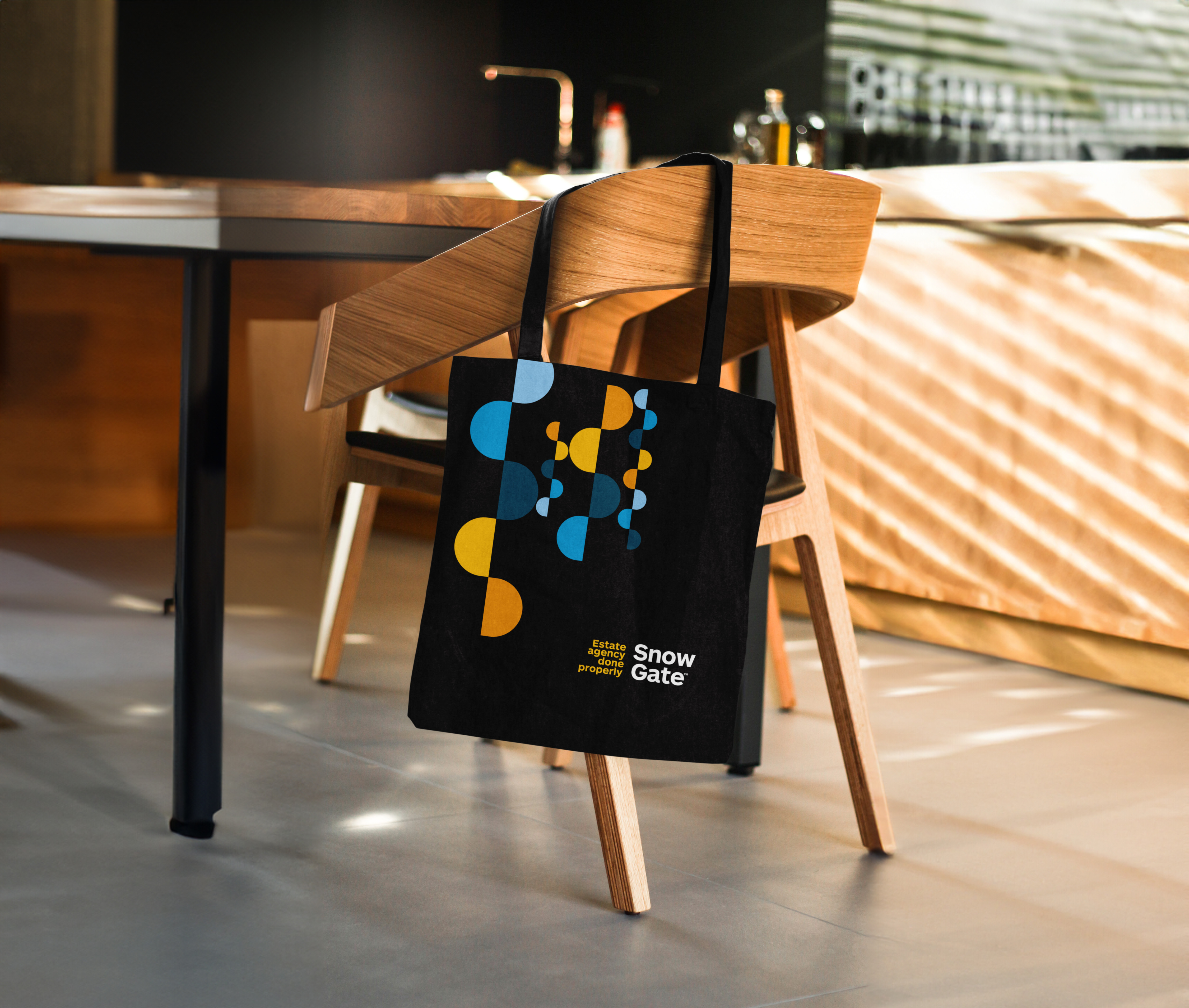SnowGate Tote Bag on a chair
